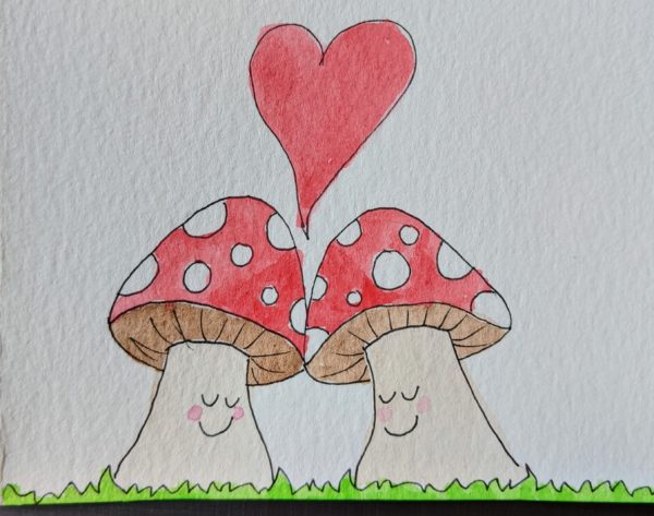 Two personified red and white mushrooms, leaning close to one other with smiles on their faces. A red heart is above them. 